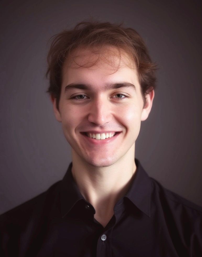 A headshot photo of Logan Jorgensen (me) in a brown shirt